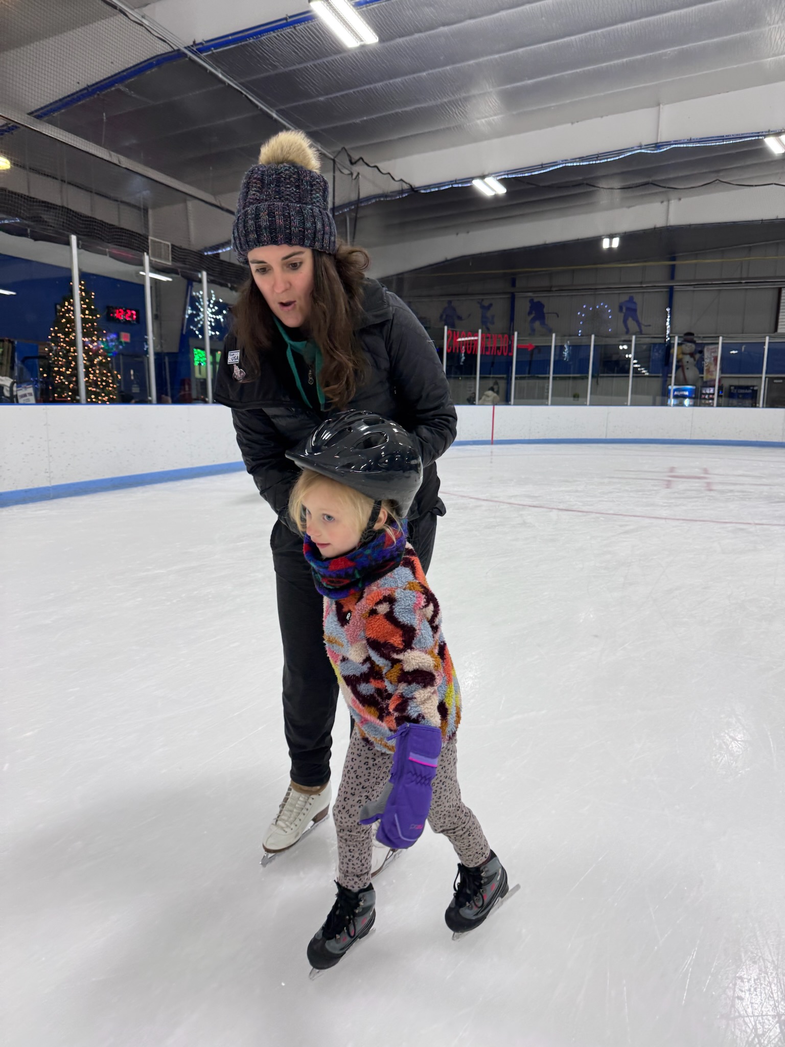 Juliana Bailey coaching a young skater on the ice